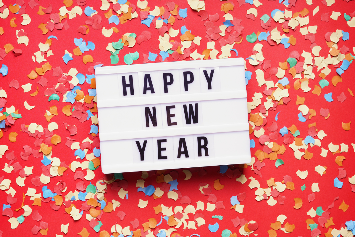 Happy New Year sign with a background of multicolored confetti