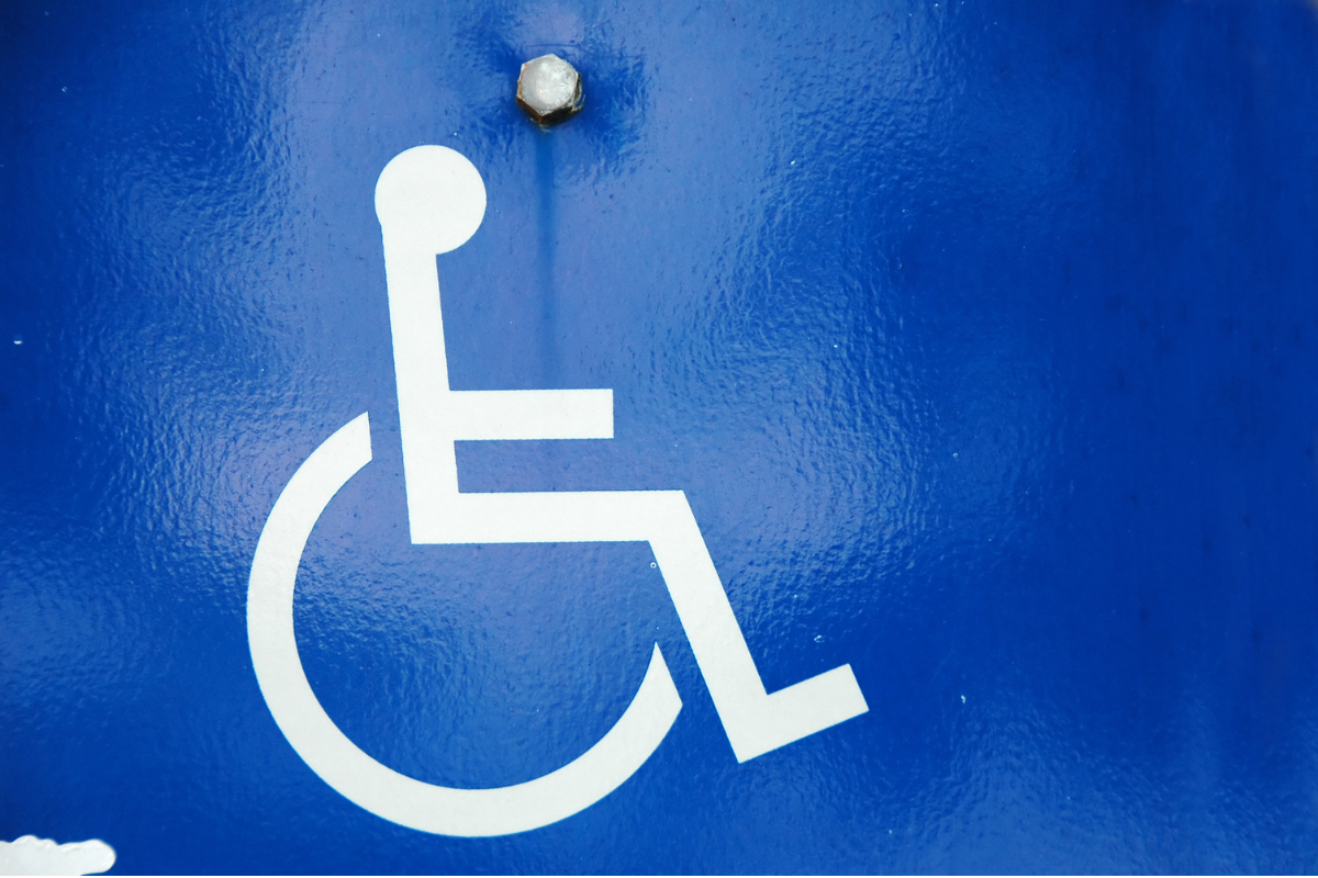 White wheelchair symbol on a blue textured background