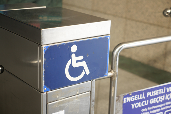 Wheelchair accessible entrance gate marked by a blue and white wheelchair icon sig