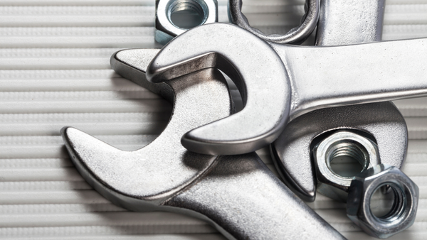 Closup photo of a pile of metal wrenches and bolts