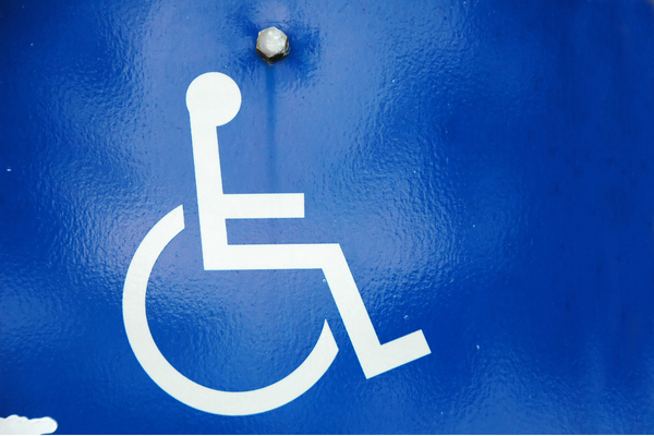 White wheelchair symbol on a blue reflective background