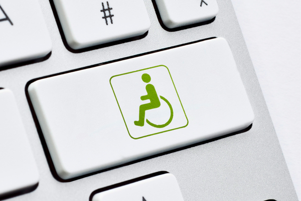 Green wheelchair symbol on a computer key