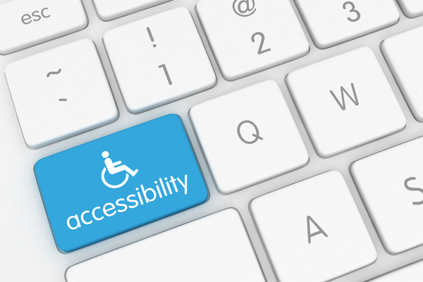 White wheelchair symbol and "accessibility" on a blue key in a white keyboard
