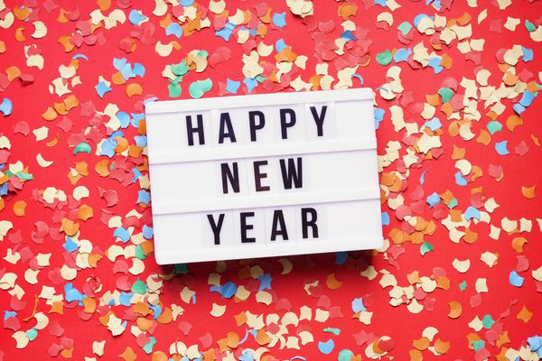 Happy New Year sign with a background of multicolored confetti
